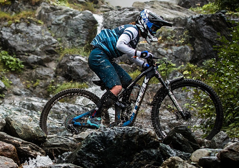 Mountain biker riding through rocky terrain