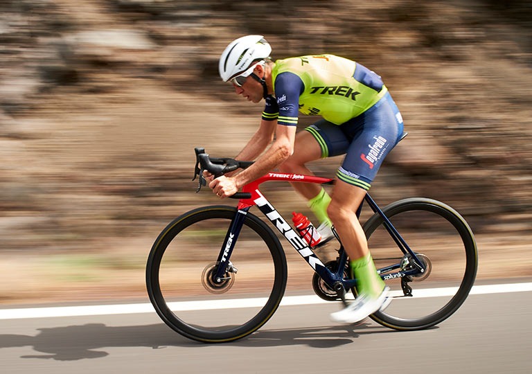 Professional cyclist on road bike in motion